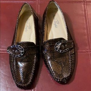 This is a lightly used brown snake loafers.